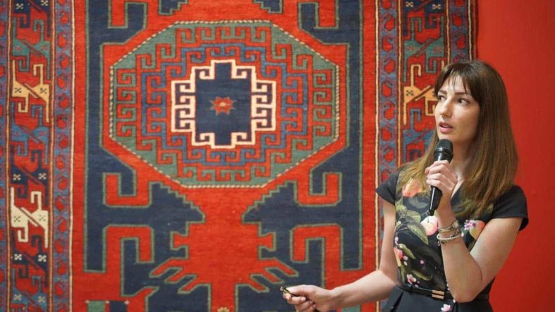 Dr. Shirin Melikova, Director of the Azerbaijan National Carpet Museum gives information about the displayed traditional Guba, Gazakh, and Karabakh carpets.